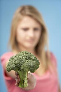 Teenage Girl Holding Fresh Broccoli