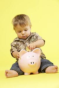 Toddler In Studio With Piggy Bank