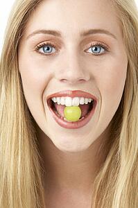Portrait Of Young Woman Eating Grape