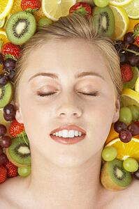 Portrait Of Young Woman Surrounded By Fruit