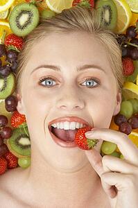 Portrait Of Young Woman Eating Strawberry