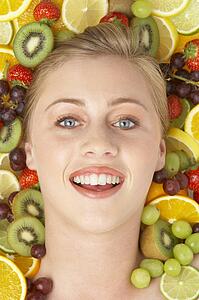 Portrait Of Young Woman Surrounded By Fruit