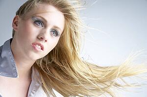 Young Woman With Hair Blowing Behind