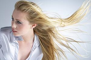 Young Woman With Hair Blowing Behind