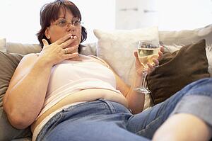 Overweight Woman Relaxing On Sofa