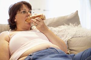 Overweight Woman Relaxing On Sofa