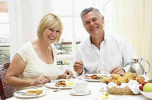 Middle Aged Couple Enjoying Hotel Breakfast