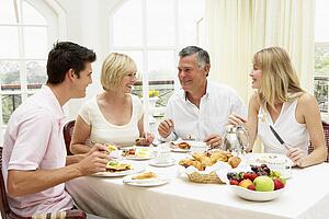 Family Group Enjoying Hotel Breakfast