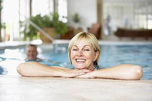 Middle Aged Couple In Swimming Pool