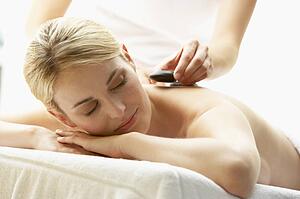 Young Woman Enjoying Hot Stone Treatment