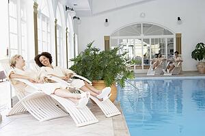 Women Relaxing Around Pool At Spa