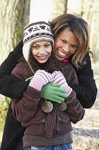 Mother And Daughter On Autumn Walk