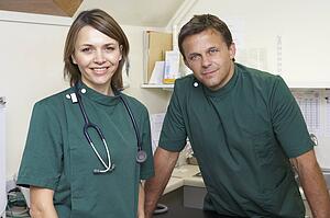 Portrait Of Male And Female Vets In Surgery
