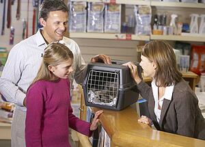 Girl And Father Taking Cat For Examination By Vet