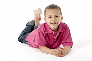 Young Boy Lying On Stomach In Studio