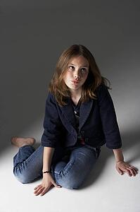 Thoughtful Girl Sitting In Studio