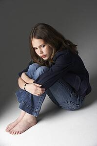 Thoughtful Girl Sitting In Studio