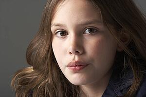 Thoughtful Girl Sitting In Studio