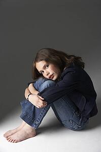 Thoughtful Girl Sitting In Studio