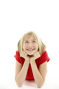 Young Girl Lying On Stomach In Studio