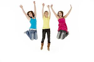 Group Of Three Young Girls Leaping In Air