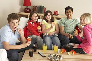 Group Of Children Eating Burgers At Home