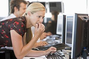 Anxious Woman Looking At Computer Monitor