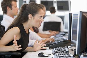 Stock Trader Looking Exasperatedly At Monitor