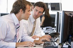 Colleagues Working Together At Computer