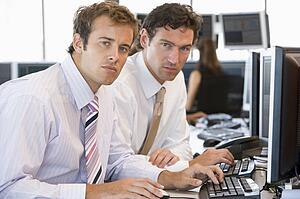 Colleagues Working Together At Computer