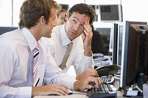 Colleagues Working Together At Computer