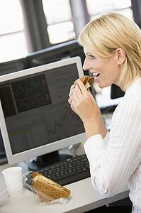 Businesswoman Enjoying Sandwich During Lunchbreak
