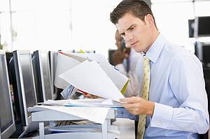 Stock Trader Looking Though Paperwork
