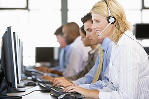Stock Traders With Headsets At Work