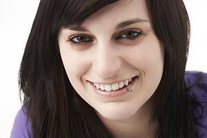 Studio Portrait Of Smiling Teenage Girl