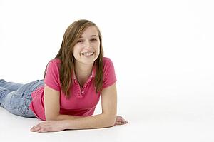 Teenage Girl Laying On Stomach