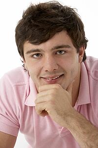 Studio Portrait Of Smiling Teenage Boy