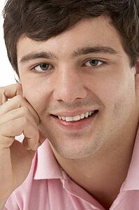 Studio Portrait Of Smiling Teenage Boy