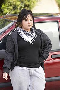 Young Woman Standing Next To Car