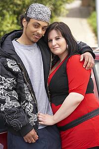 Young Couple Standing Next To Car