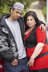 Young Couple Standing Next To Car