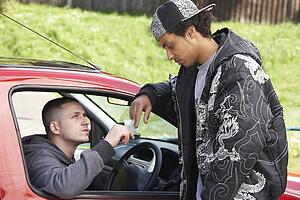 Young Man Dealing Drugs From Car