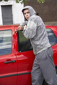 Young Man Breaking Into Car