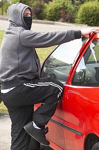 Young Man Breaking Into Car