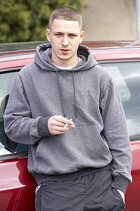 Young Man Standing Next To Car