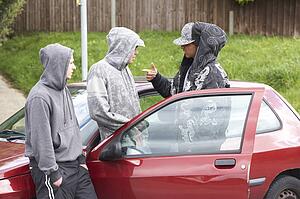 Group Of Young Men With Cars