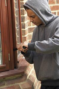 Young Man Breaking Into House