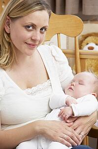 Mother Holding Baby In Nursery