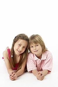 Two Children Laying on Stomach in Studio