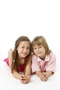 Two Children Laying on Stomach in Studio